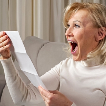 woman with receipt happy
