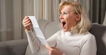 woman with receipt happy