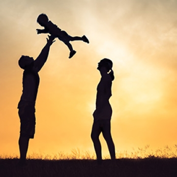 child lifted by parents